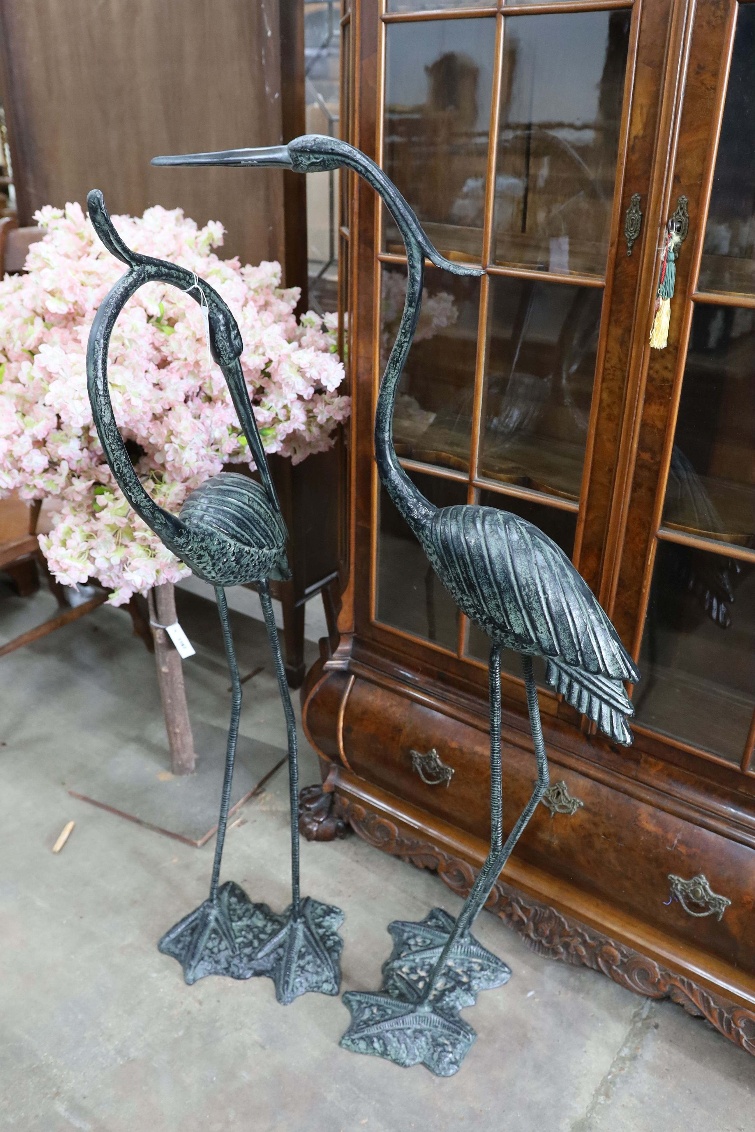 A pair of bronzed metal crane garden ornaments, larger height 136cm